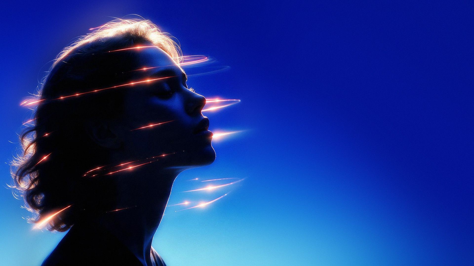 Two translucent hands reaching toward a point of light